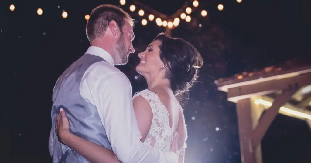 Bride and groom share their first dance outside under the stars