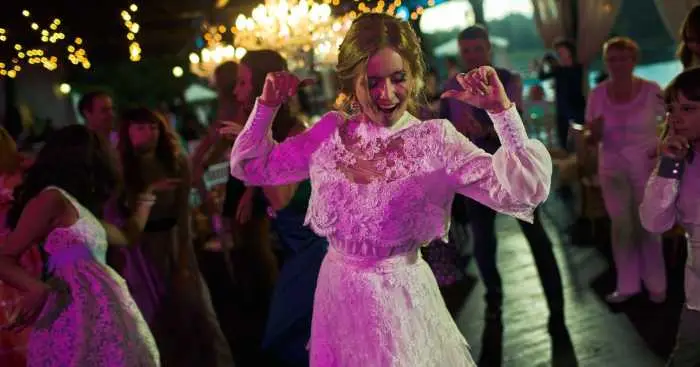 Bride dancing surrounded by her wedding guests