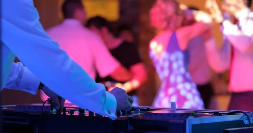 Wedding DJ playing music for dancing wedding guests