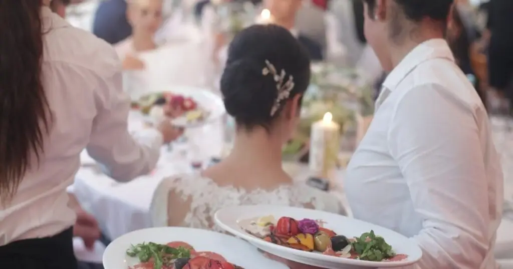 Wedding Caterer serving a bride