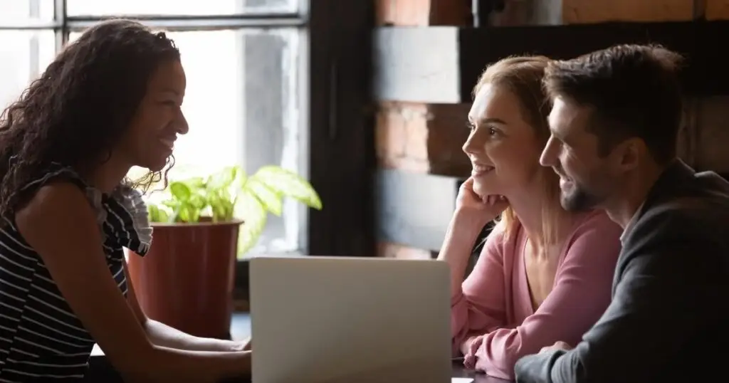 Couple sitting and talking with a wedding planner